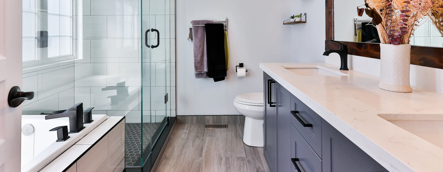 Salle de bain avec douche vitrée, vasque et miroir